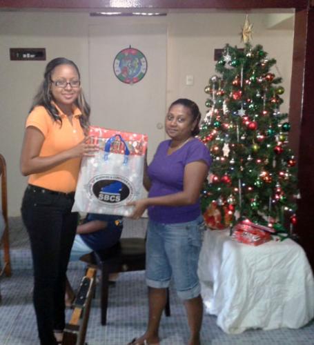 Caretaker Debra Mc Kenzie receives Christmas gifts 